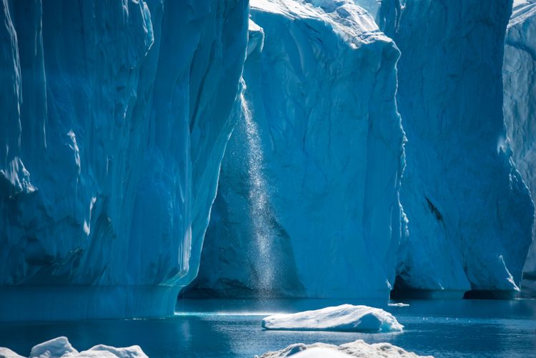Meltwater streams from iceberg, Ilulissat Icefjord, West Greenland